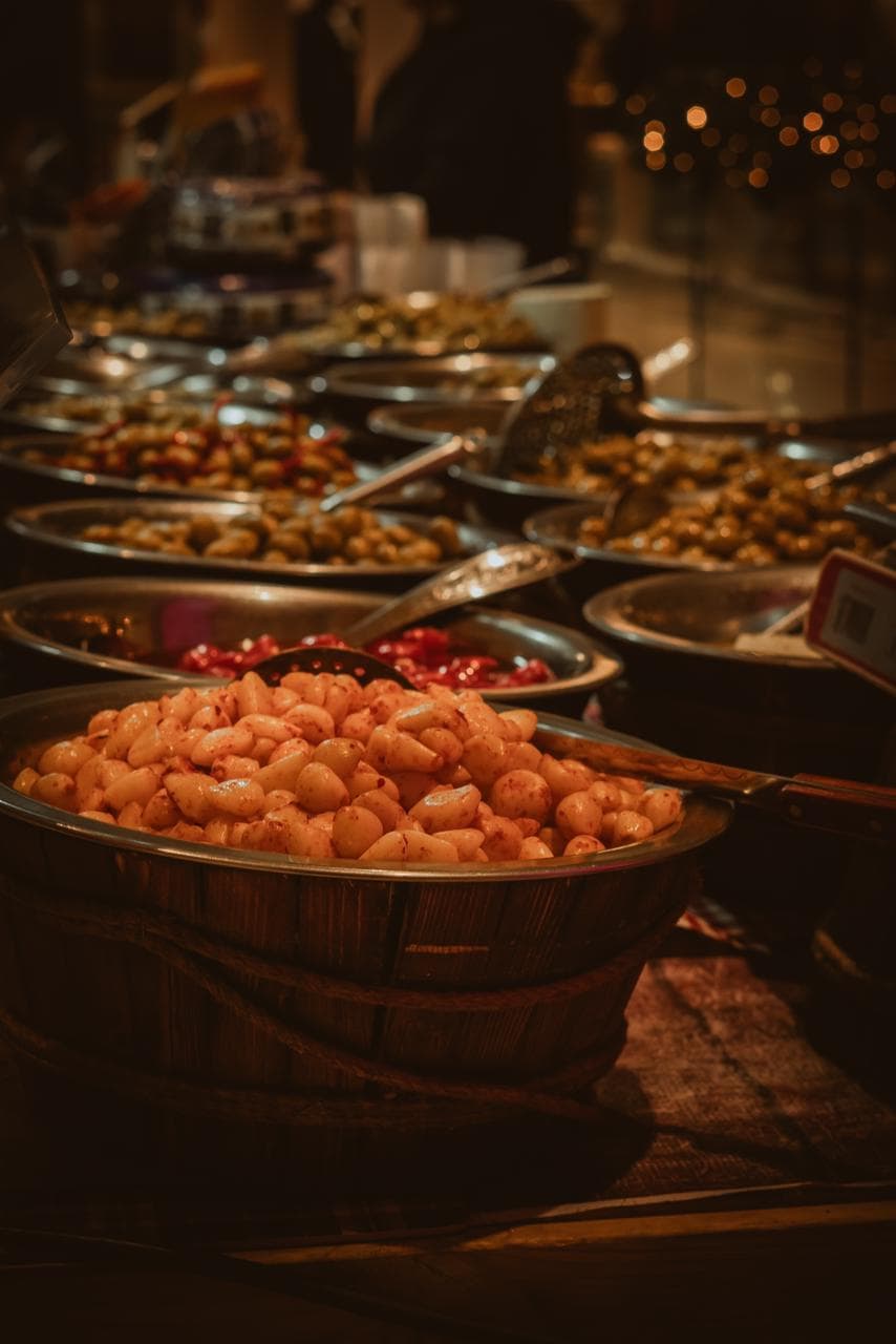 Variety of olives in market trays